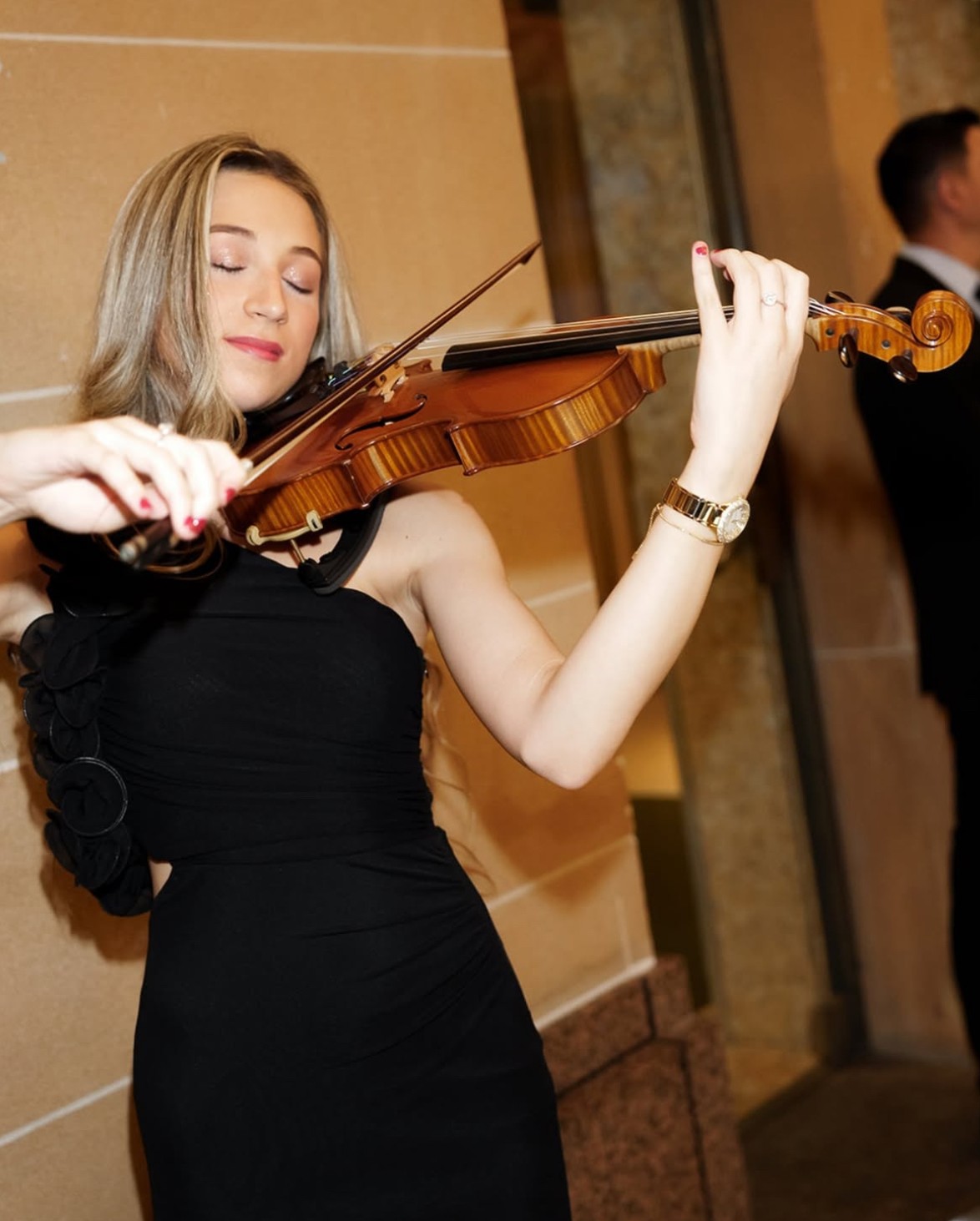 Tali playing violin at park in front of the Sydney Harbour Bridge